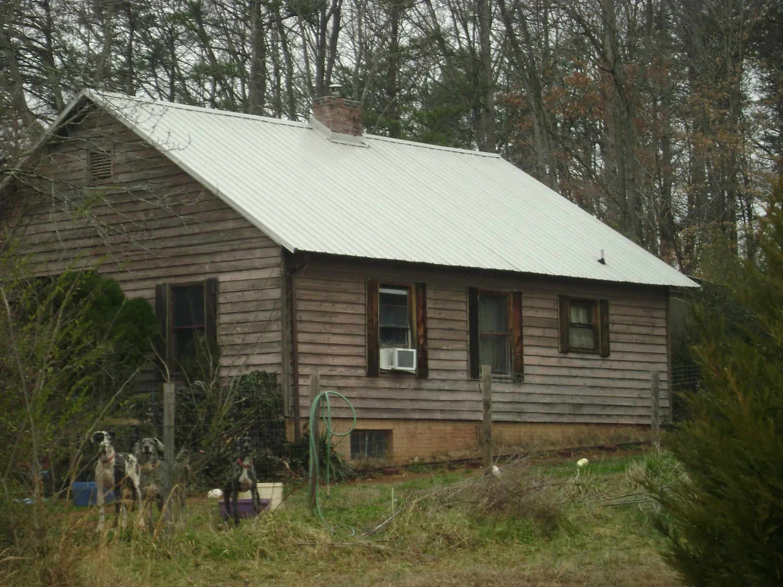 White metal roof on an old wood sided farmhouse, from a Asphalt Shingle Roof Repair job in Linden